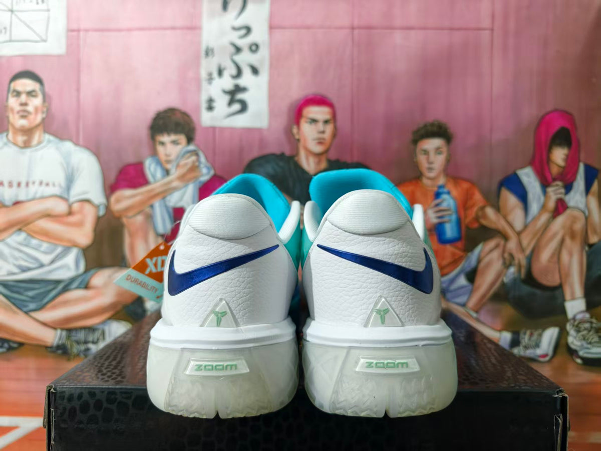 Rear view of blue and white basketball sneakers with dark blue heel accents.