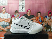 Side profile of a white basketball shoe with black Swoosh and green heel detailing.