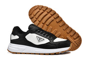 Pair of black and white low-top sneakers showing the gum-colored tread.