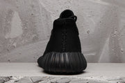 Rear view showing the black heel construction and segmented ribbed outsole.
