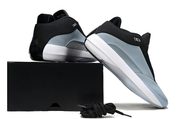 Blue-gray Jordan 40 sneakers shown from the heel and side beside a black box.