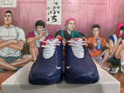 Front view showing the navy blue perforated toe panels, white laces, red accents, and visible Nike swooshes.