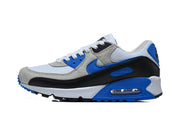 Side view of white, grey, blue, and black Nike Air Max 90 sneakers.