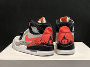 Rear view of the pair showing coral heel overlays, black collars, Jordan branding, and patterned side panels.