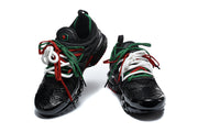 Front and angled views of black Nike Air Max Plus sneakers with multicolor laces.