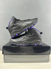 Black and purple high-top sneakers displayed in a stacked side profile on a shoebox.