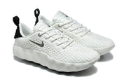 Three-quarter view of the white lace-up sneakers with black heel accents, perforated panels, and sculpted soles.