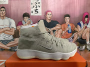 Side profile of a light gray high-top sneaker with a Swoosh and ribbed white sole