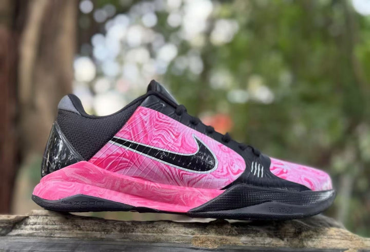 Side view of pink and black Nike Kobe 5 basketball shoes