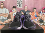 Front view of the black and purple basketball sneakers with dark laces, black tongues, and purple side accents.