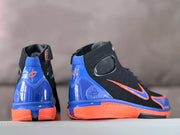 Rear and side views showing the blue heel panels and orange midsoles