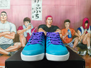 Front view highlighting the teal toe boxes, purple laces, and white textured outsoles.