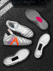Several views of the grey and orange sneakers, including the patterned outsole and separated sole components.