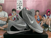 Pair of grey basketball shoes shown from the side and at an angle