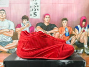 Side view of a red shoe with a Swoosh and sculpted outsole