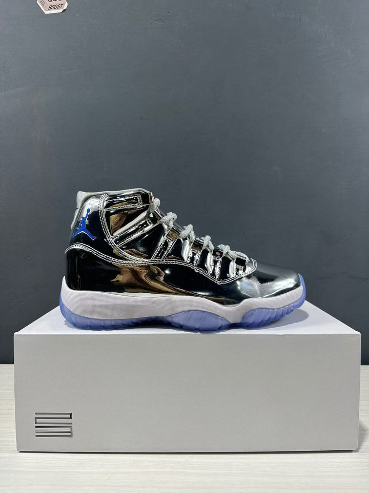 Side view of a reflective silver and black Jordan high-top sneaker displayed on a shoe box.