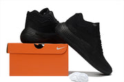 All-black Nike Precision 8 shoes displayed with an orange shoebox, including an outsole view.