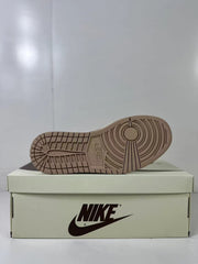Underside view showing the brown rubber outsole with circular forefoot traction and segmented tread.