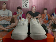 Front view of the pair showing white laces, textured white uppers, and layered white toe outsoles.