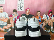Rear view of white and black Nike sneakers showing heel details and thick midsoles.