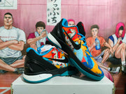 Angled view of the Nike basketball sneaker pair displaying colorful graphic side panels, blue laces, black heel sections, and contrasting outsoles.