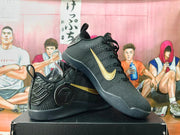 Pair of black basketball shoes with gold-colored Swooshes, shown from the side.