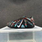 Close side view of a black sneaker with multicolor patterned panels, a contrasting Swoosh, and ZoomX marking.