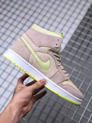 Side profile highlighting the layered beige panels, contrasting Swoosh, white midsole, and yellow-green outsole edge.
