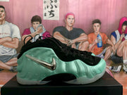 Side profile of a mint green Nike sneaker showing metallic side branding, black detailing, and a translucent outsole.