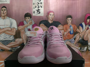 Front view of pink Nike basketball sneakers with matching laces and gray toe trim.