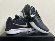 Pair of black low-top basketball shoes with silver-tone Swoosh and white midsoles