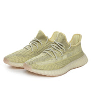 Three-quarter view of olive green Yeezy 350 V2 sneakers showing the patterned upper, laces, and ribbed outsole.