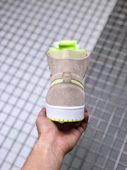 Rear view showing the beige heel panel, white midsole, and neon yellow-green outsole accent.