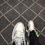 Top-down view of the perforated toe box, white laces and grey eyelet overlays.