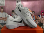 Angled view of white and grey Nike Zoom basketball shoes with black Swoosh accents.