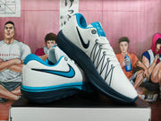 Angled view of white Nike LeBron shoes with black-and-blue Swoosh detailing