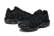Pair of black Nike Air Max Plus sneakers shown from the side