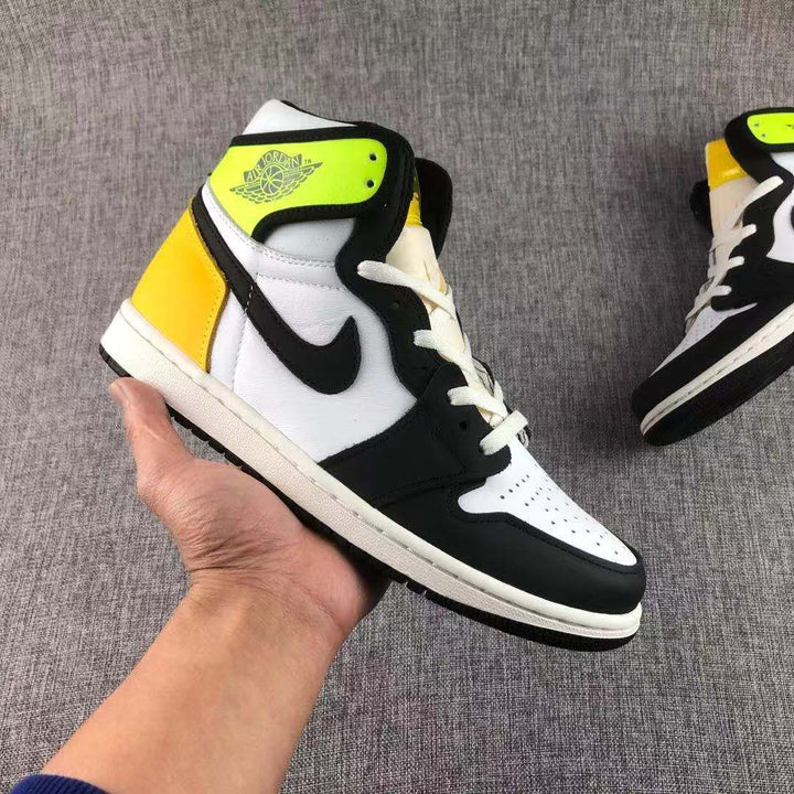Close-up side view of a Volt Gold, black and white high-top Jordan sneaker.