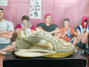 Side view of an olive and cream basketball shoe with patterned panels and gold-toned logo