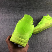 Rear view of the fluorescent green sneaker showing the padded heel and tonal construction.