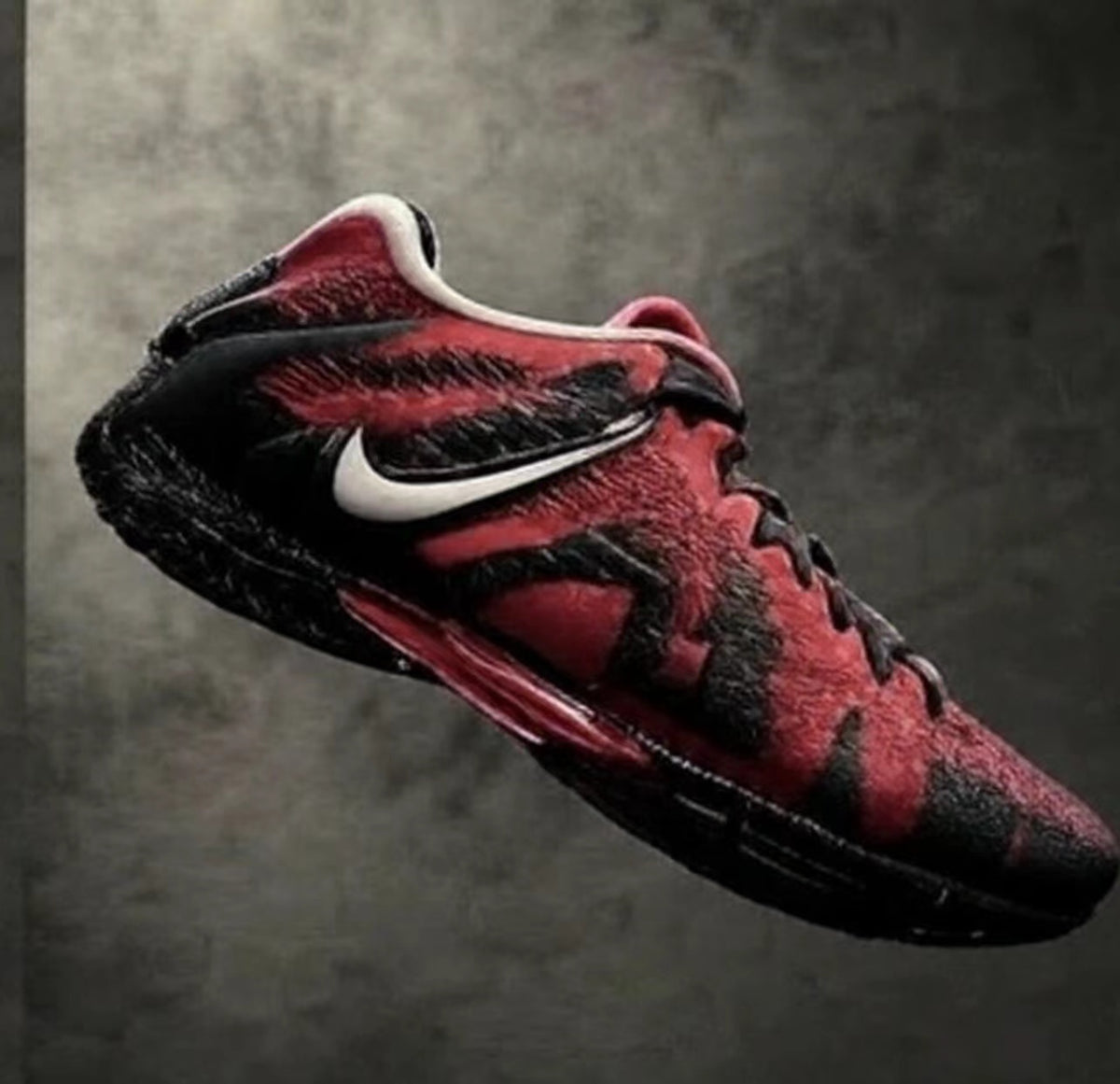 Red and black Nike sneakers with a white Swoosh, black laces, and a black outsole shown at an angle.