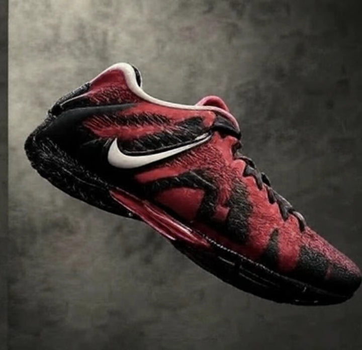 Red and black Nike sneakers with a white Swoosh, black laces, and a black outsole shown at an angle.
