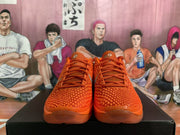 Front view of the orange Nike Zoom sneakers showing the textured toe boxes, orange laces, and translucent-looking forefoot soles.