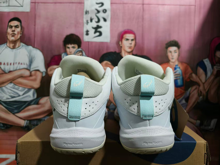 Rear view of white ASICS basketball shoes with pale mint-green heel tabs and high-cut collars.