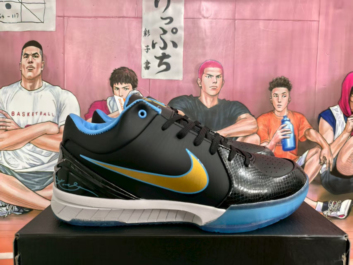 Side view of black Nike Brunson PE basketball sneakers with blue and gold Swoosh detailing on a black box.
