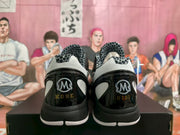 Rear view showing Kobe and GiGi heel graphics with black, white, and glossy panel details.