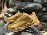 Close angled view of the metallic gold upper and patterned heel panel