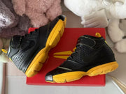 Top-down view of the sneakers arranged on a red shoebox.