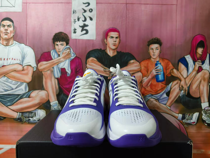 Front view of white and purple Nike Kobe basketball shoes with yellow accents