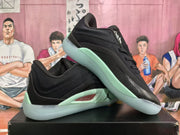Black and mint green Jordan basketball sneakers displayed on a box, shown from the side and upper angle.